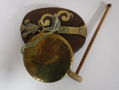 An early twentieth century brass gong with beater