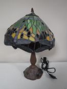 A Tiffany style table lamp with dragon fly leaded shade