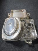 A tray of early twentieth century plated entree dishes with covers