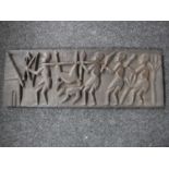 A carved hardwood panel depicting tribal huntsmen