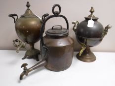 An antique copper hanging kettle together with two samovars