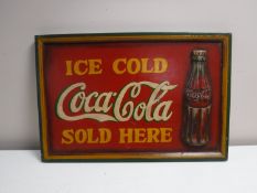 A wooden Coca Cola advertising panel