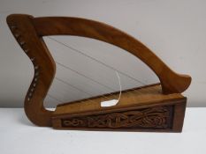 A carved miniature twelve string harp