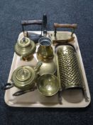 A tray of assorted brass ware including flat irons, graters,