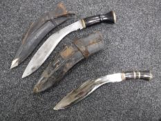 Two Kukri knives in leather sheaths