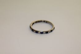 An 18ct white gold sapphire and diamond eternity ring