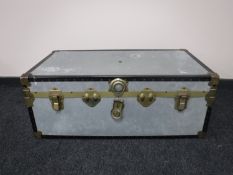 A tailors dummy and a metal shipping trunk