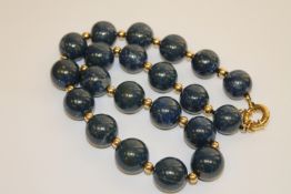 A large blue agate necklace with gold clasp,