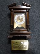 A mahogany mantel clock with an embossed brass table box