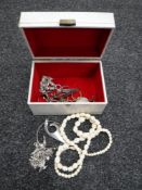 A jewellery box containing a silver charm bracelet and other white metal jewellery,