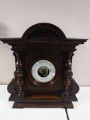 A Victorian aneroid barometer in carved mahogany case.