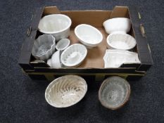 A box containing twelve antique glazed pottery jelly moulds