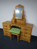 A pine knee hole dressing table with mirror and stool