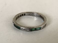 A diamond and emerald eternity ring,