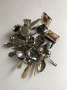 A box containing silver bridge stand, silver and plated teaspoons,