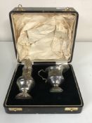 A cased silver strawberry set, comprising sugar caster and cream jug, S Blanckensee & Son Ltd,
