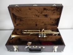 A Elkharl brass trumpet in case