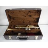 A Elkharl brass trumpet in case