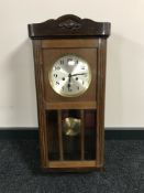 An early 20th century oak cased wall clock with silvered dial,