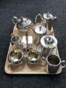 A tray of silver plated ware including two tea services