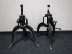 Two adjustable industrial metal tripod stands