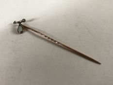 A Victorian gold hat pin set with an opal