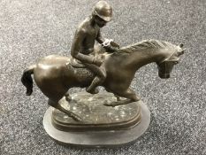 A bronze figure of a jockey on horseback,