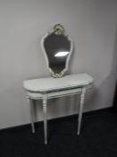 A cream and gilt shaped hall table with mirror