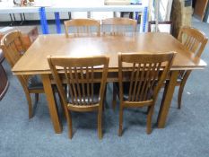 A Julian Bowen extending table and six rail back chairs