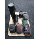 A tray of four cameras including Helina, Kodak, camera lenses,