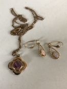 A 10ct gold pendant on chain set with a pink topaz,