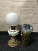 A Victorian glass and brass paraffin lamp together with a glazed pottery ewer stamped 'Adamesk'.