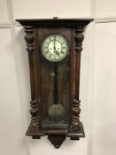 A Victorian walnut wall clock with enamelled dial