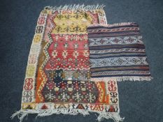 Two eastern fringed rugs
