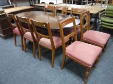 Eight Victorian oak dining chairs and a Regency style dining table with leaf