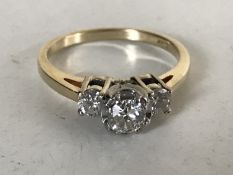 A 14ct gold three stone diamond ring, the total diamond weight estimated at 0.