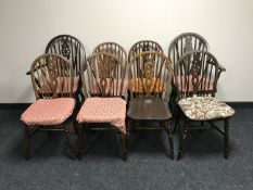 Eight oak wheel back dining chairs
