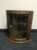 An oak Arts & Crafts leaded door wall cabinet