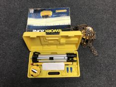 A cased laser level together with a 500kg chain block and a boxed Workzone pressure washer