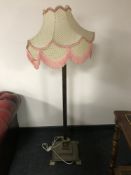 An antique brass Corinthian column standard lamp with shade