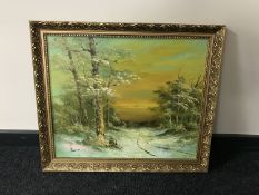 A gilt framed oil on board depicting a winter landscape
