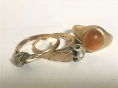 Two 9ct gold diamond set rings and an amber ring, 7.