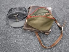 A vintage leather satchel and two military hats, Russian and German,