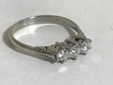 A platinum three stone diamond ring,