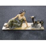 An Art Deco chalk figure of a lady seated with goat,