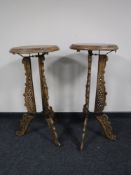 A pair of circular Eastern style plant stands on three way supports