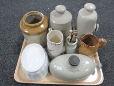 A tray of three antique stoneware hot water bottles, glazed pottery brush pot, china jelly mould,