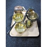 A tray of antique brass ware : three graduated sieves, two brass sauce pans,