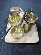 A tray of antique brass ware : three graduated sieves, two brass sauce pans,