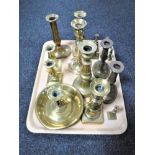 A tray of assorted brass candlesticks